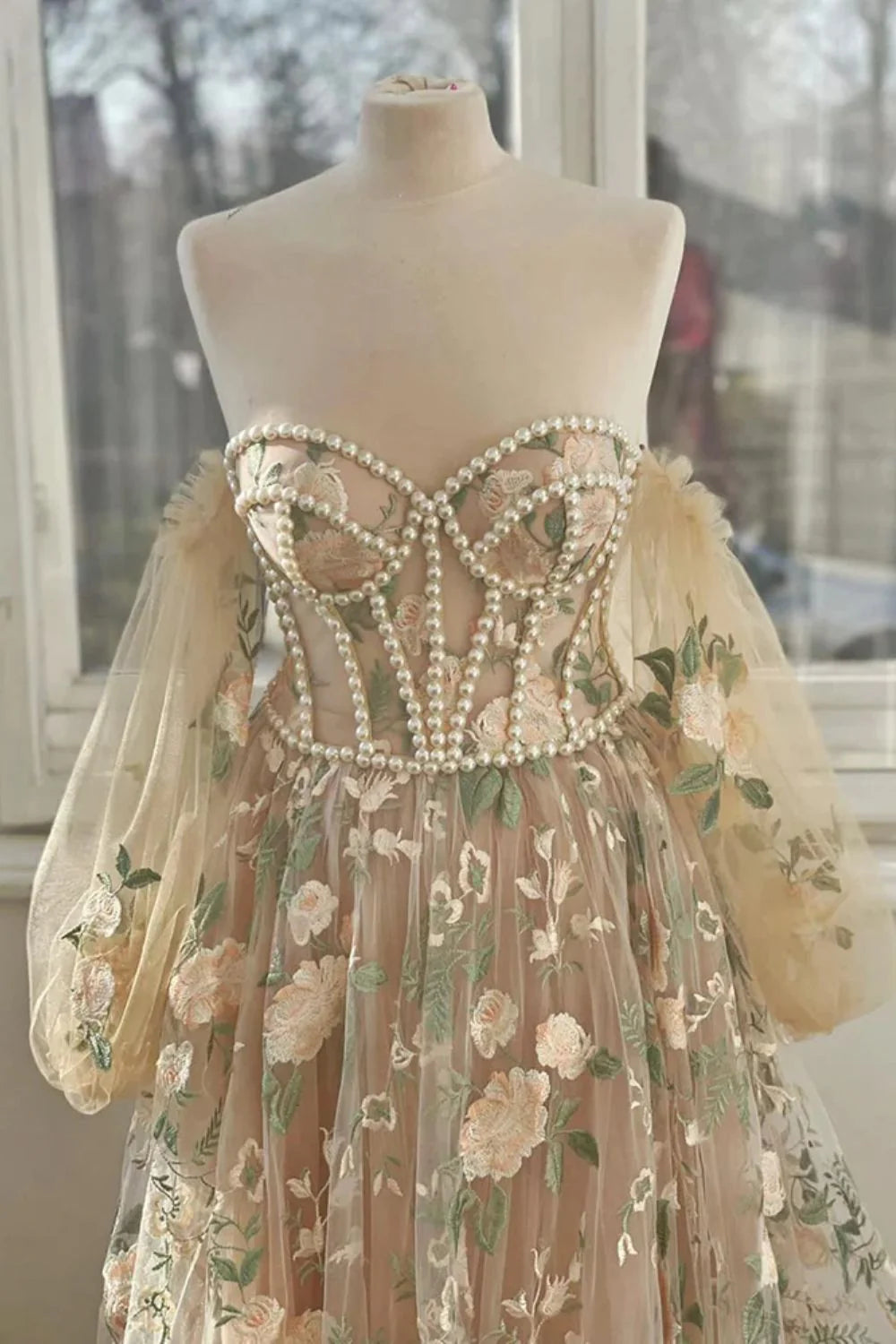 Long sleeved sweet and elegant sheer dance dress adorned with pearls and decals