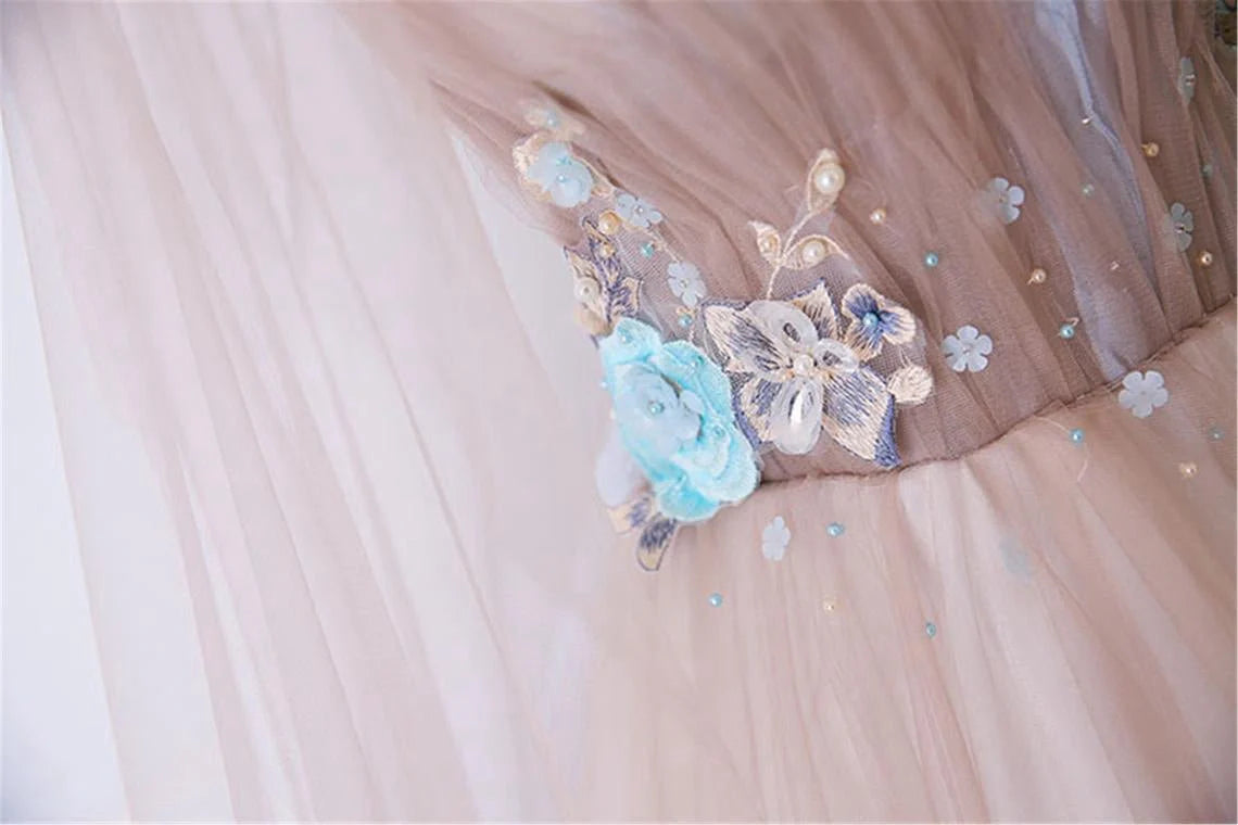 V-neck sheer ball dress with unique embellishments and floor sweeping one-fifth dress
