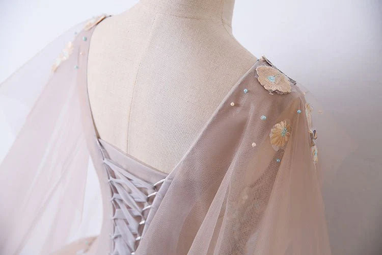 V-neck sheer ball dress with unique embellishments and floor sweeping one-fifth dress