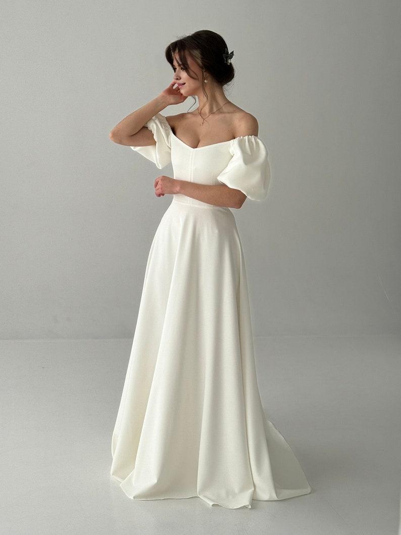 A Modest Dress With Short Sleeves An Ivory-colored Dress A Maxi Wedding Dress A Simple Wedding Dress