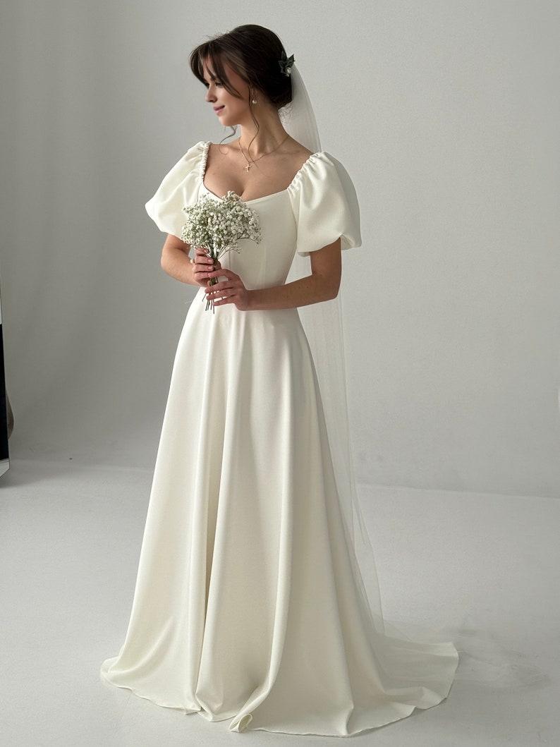 A Modest Dress With Short Sleeves An Ivory-colored Dress A Maxi Wedding Dress A Simple Wedding Dress