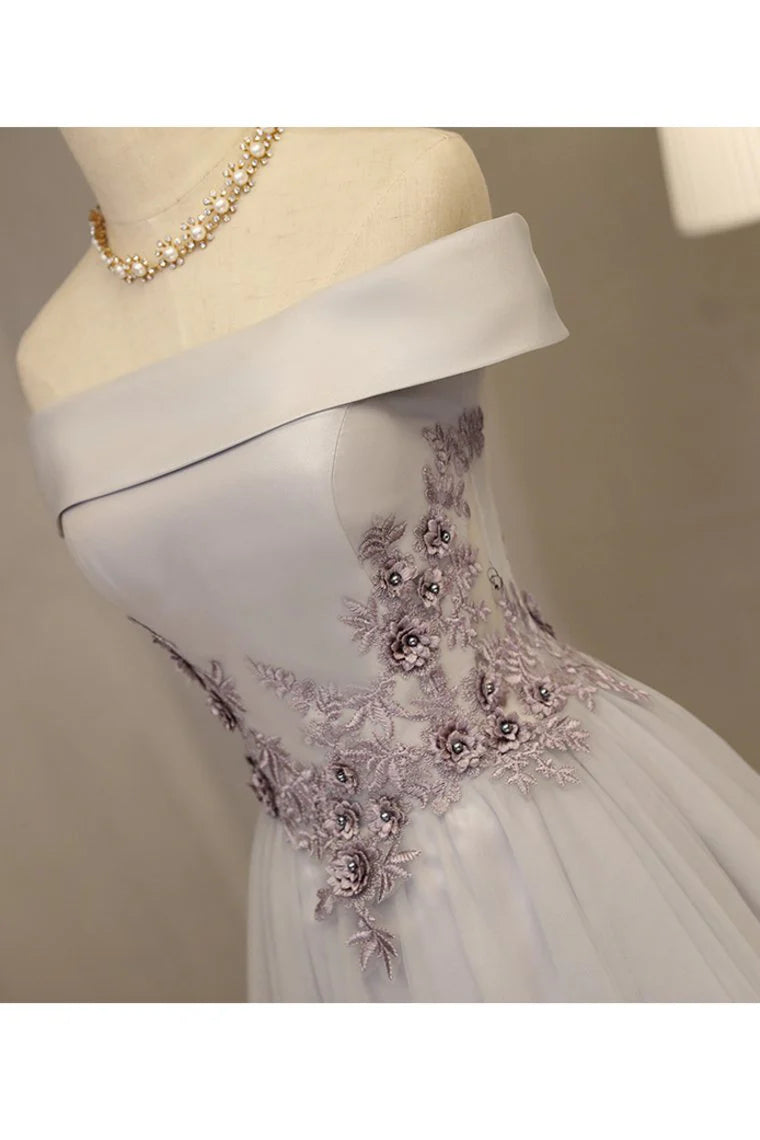 Formal ball dress with a one line boat neck and sheer embellishments featuring stickers and handmade flowers