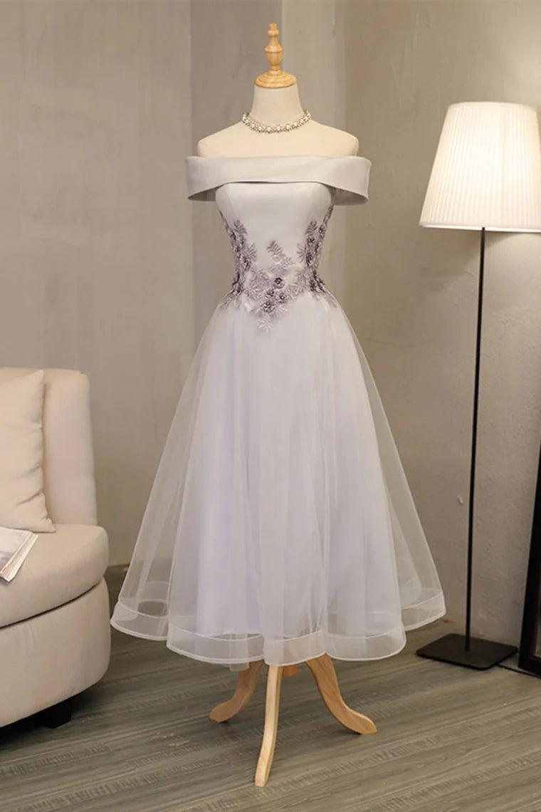 Formal ball dress with a one line boat neck and sheer embellishments featuring stickers and handmade flowers
