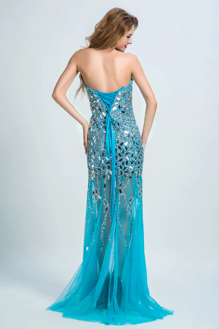 Sweetheart formal dress with beaded embellishments wrapped in sweeping tails