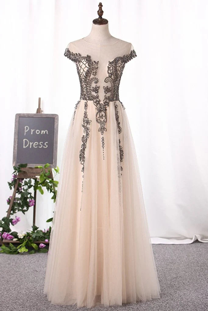 Beautiful sheer ball dress with A-line beto hat sleeves and dewdrops on the back