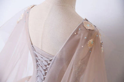 V-neck sheer ball dress with unique embellishments and floor sweeping one-fifth dress