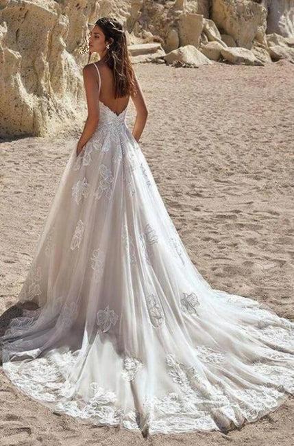 Ivory colored spaghetti length A-line bridal gown