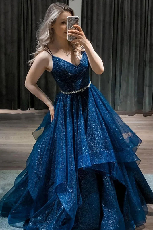 A sparkling blue V-neck with a deep blue belt and a long, fluffy blue formal evening dress for a ball
