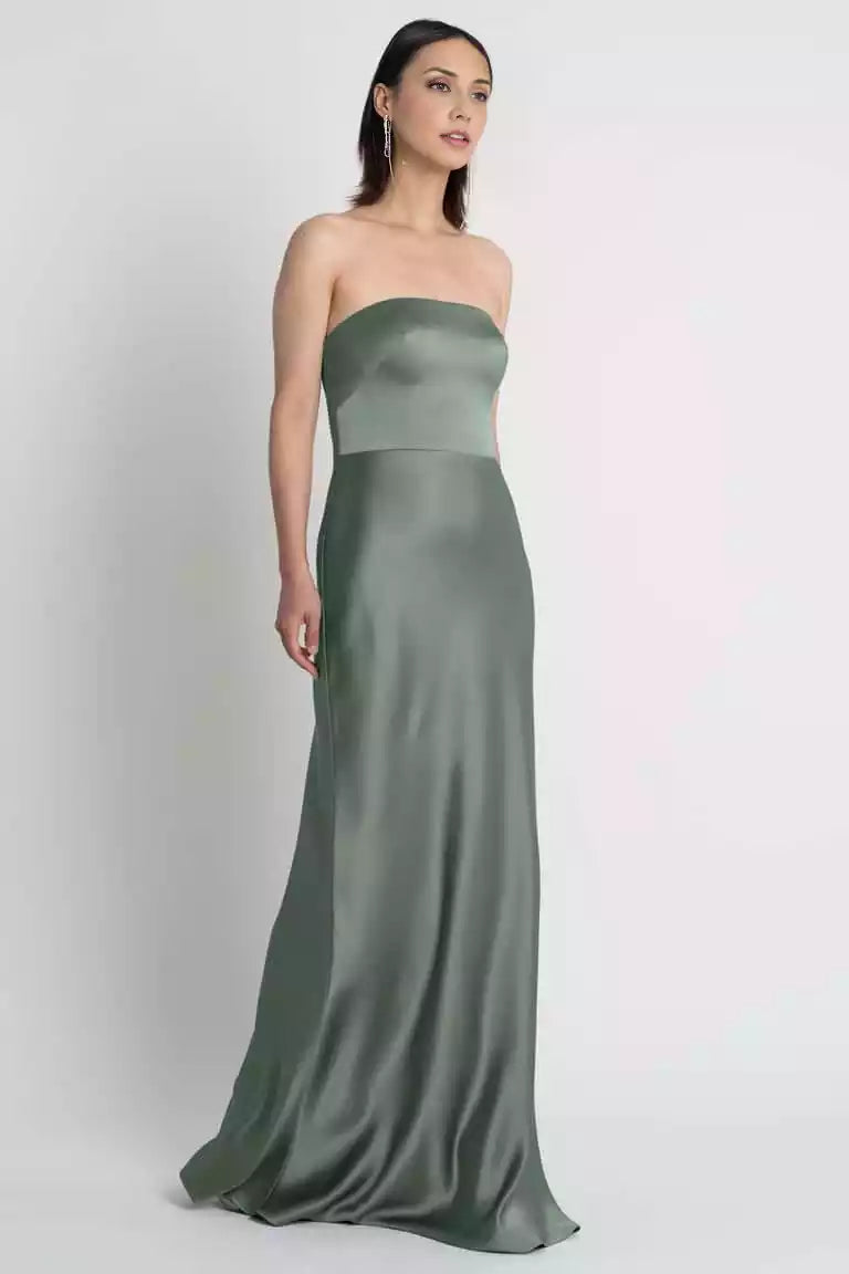 The fashionable satin off shoulder neckline and tight diagonal cut skirt showcase the timeless beauty of Evening Dresses